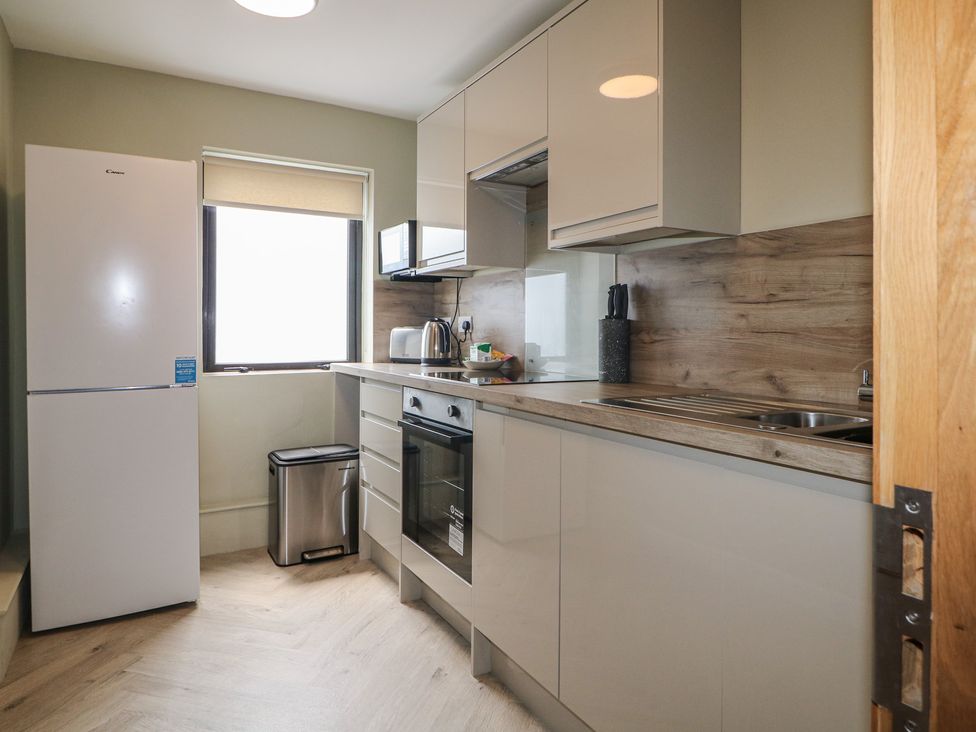 A kitchen with appliances and cabinetry at Flat 1 in Littlehampton