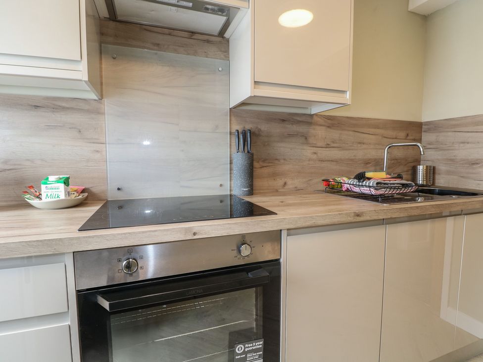 A kitchen with a sink and cooker at Flat 1 in Littlehampton