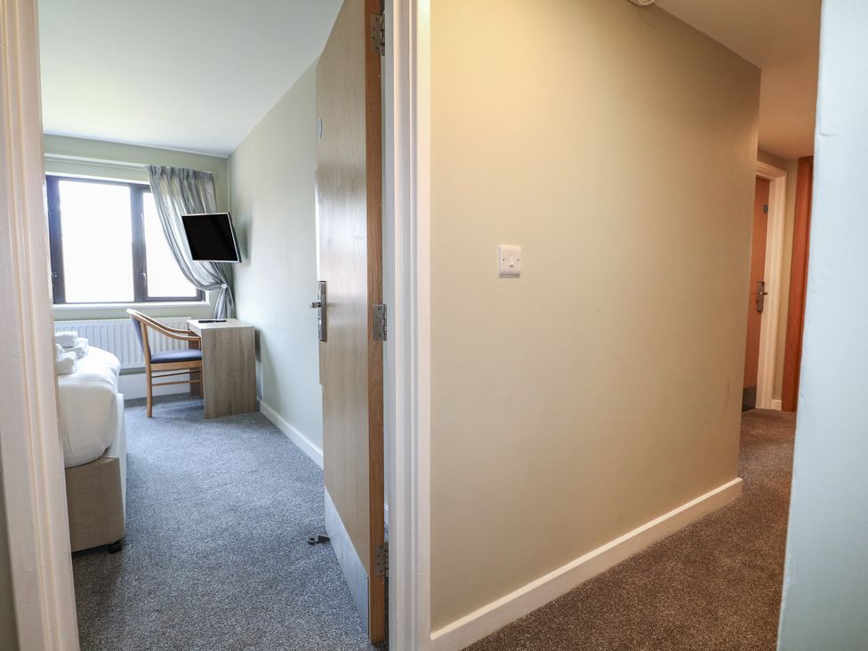 A bedroom with a bed and desk at Flat 1 in Littlehampton