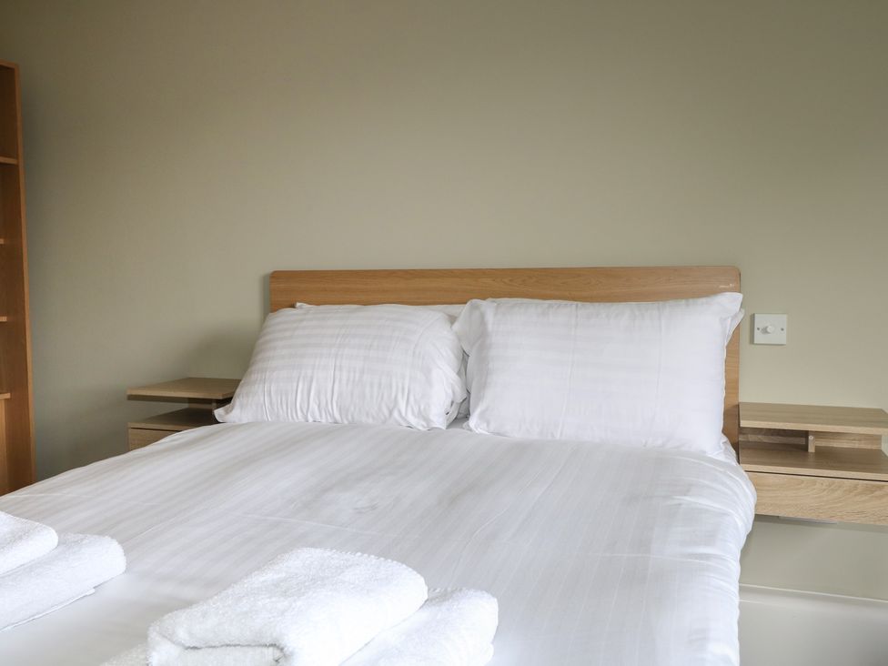 A bedroom with a bed and pillows at Flat 1 in Littlehampton