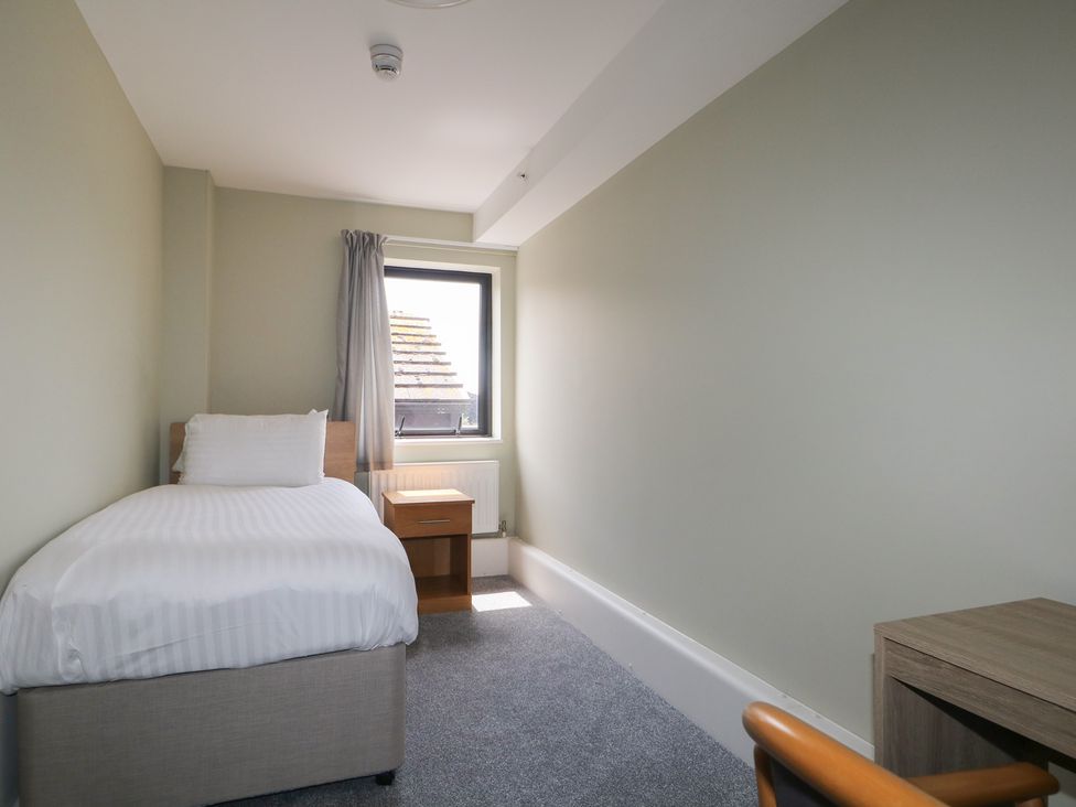 A bedroom with a single bed and desk at Flat 1 in Littlehampton
