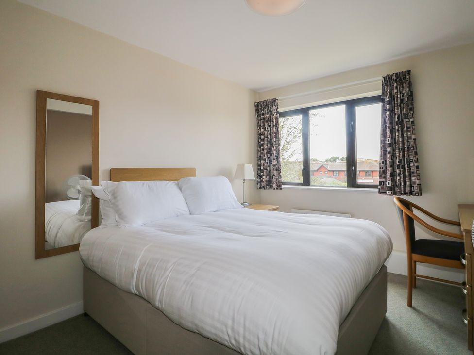 A bedroom with a bed and a desk at Flat 2 in Littlehampton