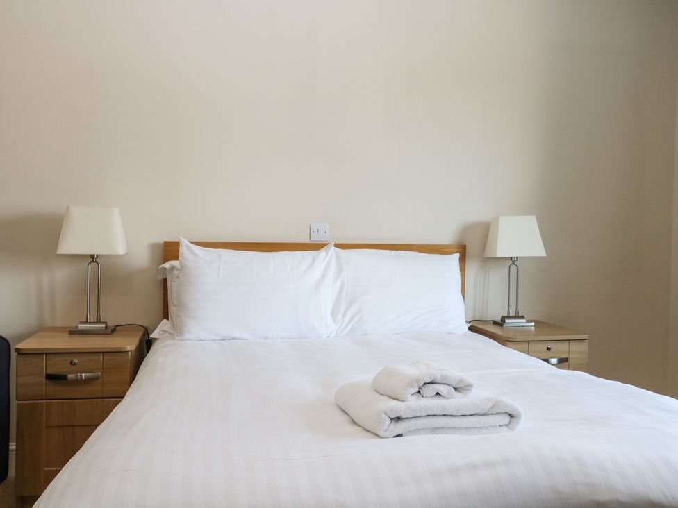 A bedroom with a bed and lamps at Bedroom 9 in Littlehampton