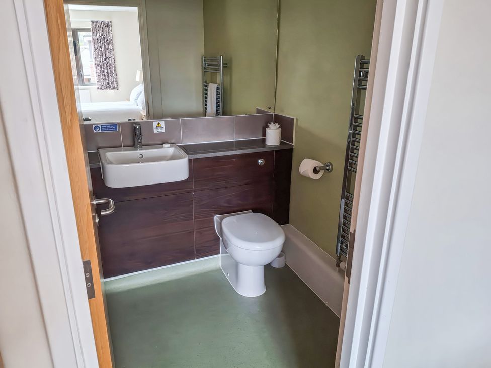A bathroom with a sink and toilet at The Driftwood Dwelling at Marine Court in Littlehampton