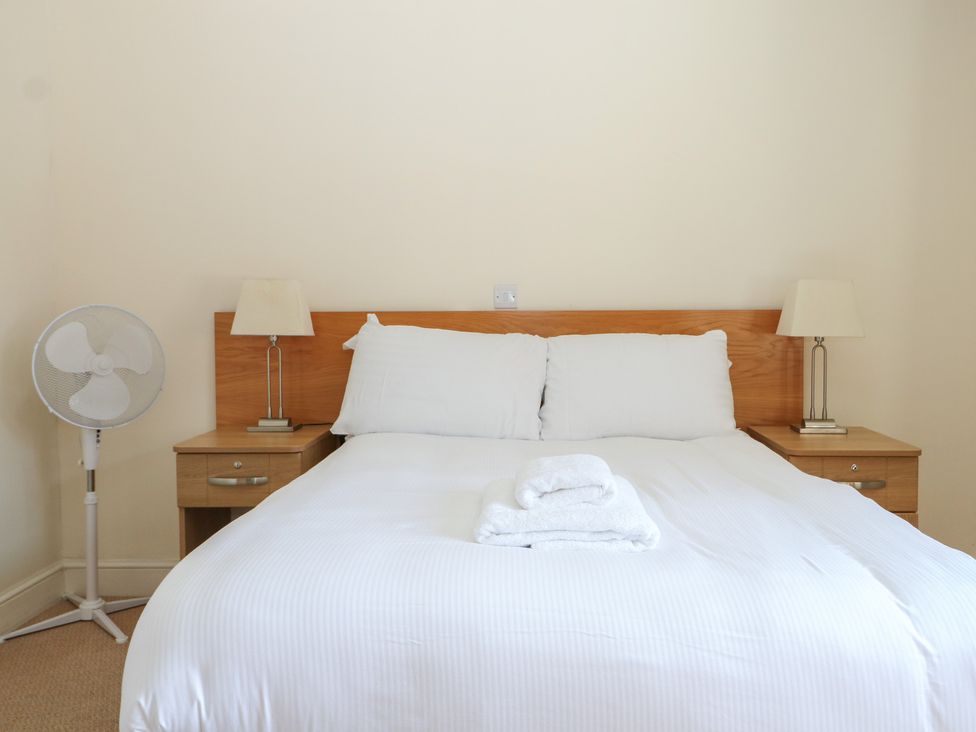 A bedroom with a bed and bedside tables at Sunset Quarters at Marine Court Littlehampton