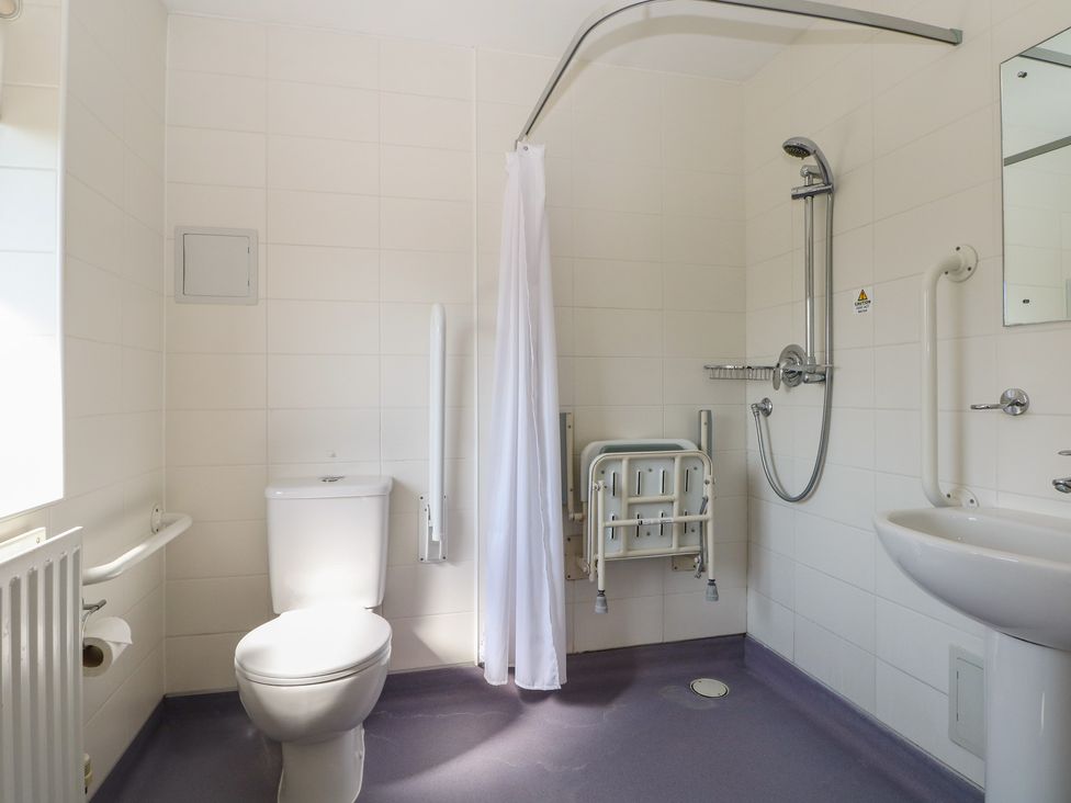 A bathroom with a toilet and sink at Sunset Quarters at Marine Court Littlehampton