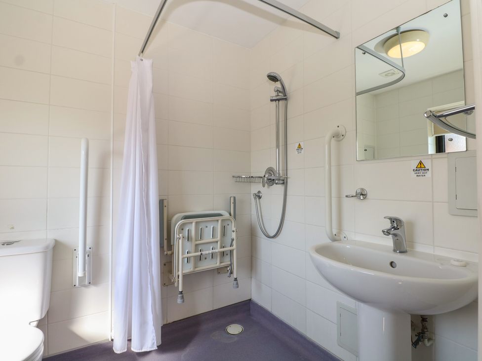 A bathroom with a shower, sink, and toilet at Sunset Quarters at Marine Court in Littlehampton