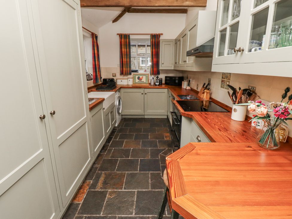 A kitchen with cabinets and appliances at 3 Christon Bank Mews in Alnwick