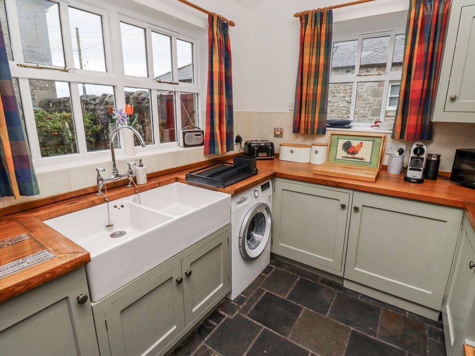 A kitchen with a sink and washing machine at 3 Christon Bank Mews in Alnwick