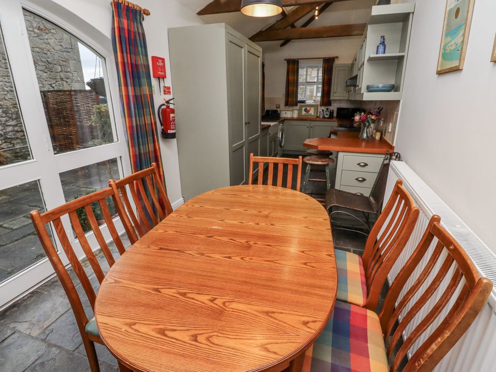 A dining room with a wooden table and chairs at 3 Christon Bank Mews in Alnwick