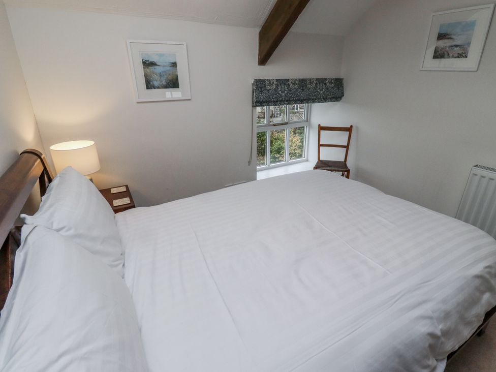 A bedroom with a bed and lamp at 3 Christon Bank Mews Alnwick