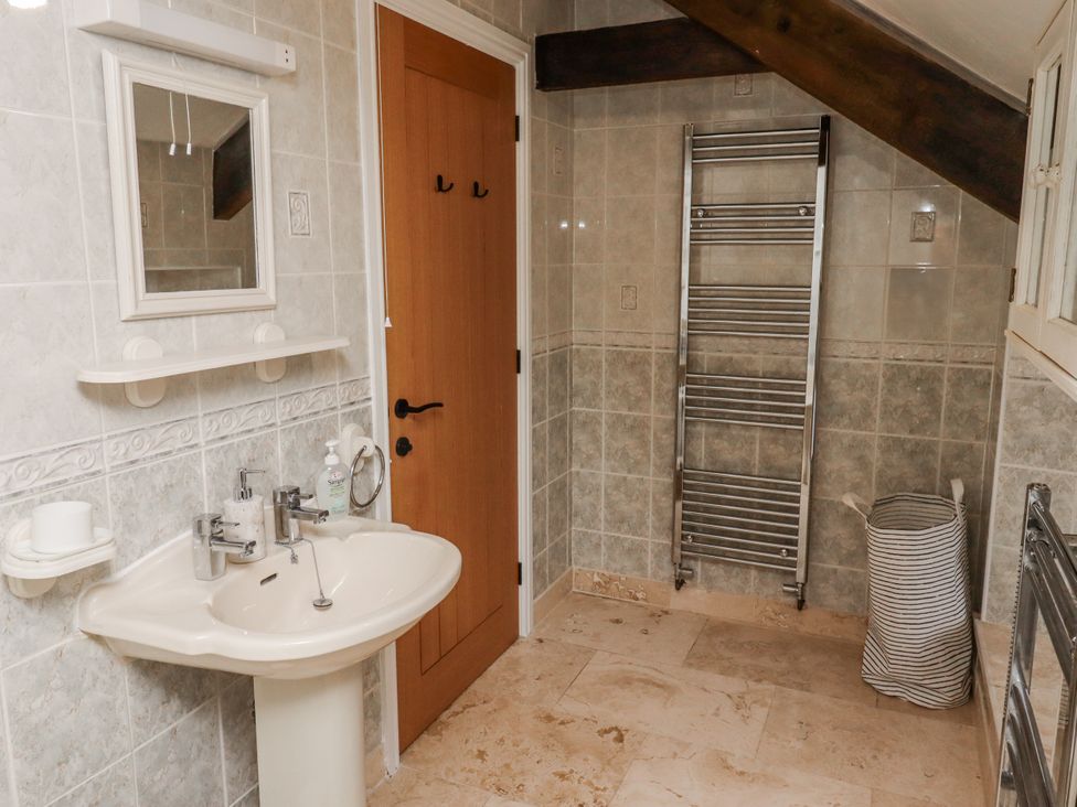 A bathroom with a sink and mirror at 3 Christon Bank Mews in Alnwick