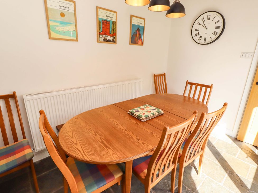 A dining room with a table and chairs at 3 Christon Bank Mews in Christon Bank