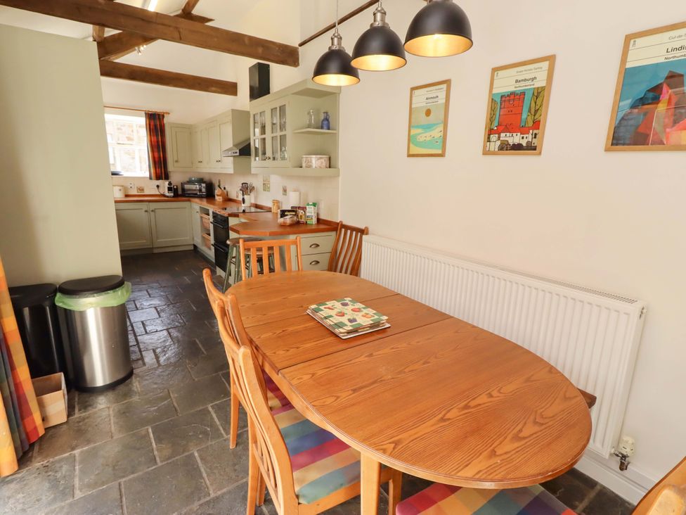 A dining area with table and chairs in a kitchen at 3 Christon Bank Mews Christon Bank