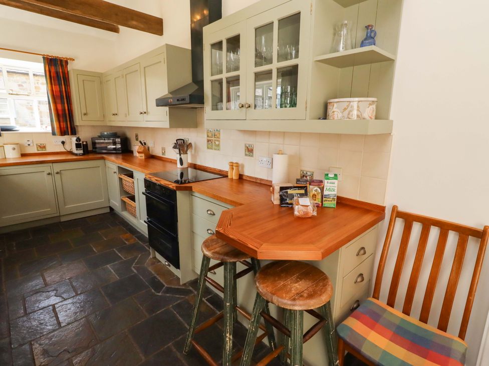 A kitchen with cabinets and counter space at 3 Christon Bank Mews, Christon Bank