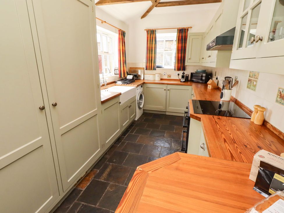 A kitchen with appliances and wooden worktops at 3 Christon Bank Mews in Christon Bank
