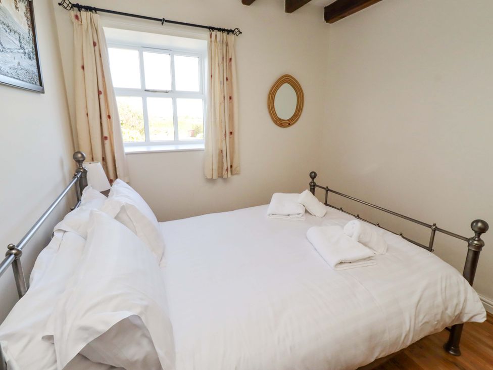 A bedroom with a bed and a window at 3 Christon Bank Mews Christon Bank