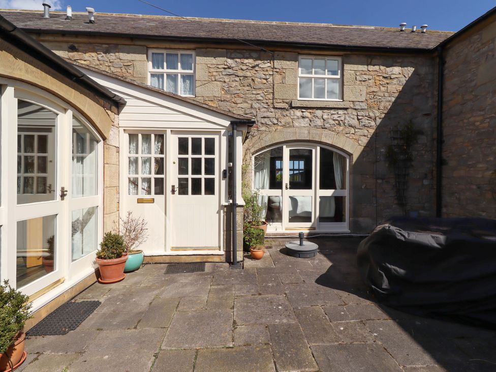 An outdoor area with stone walls and doors at 3 Christon Bank Mews in Christon Bank