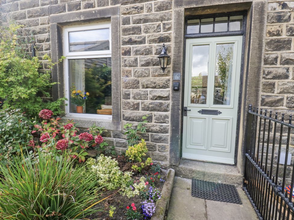 A door and window with plants at Centenary Cottage in Skipton