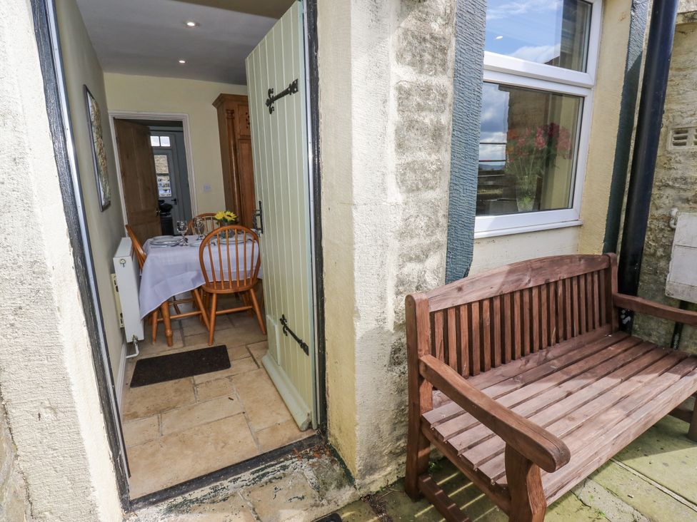 A dining room seen through an open door at Centenary Cottage, Skipton