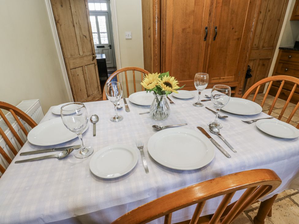 A dining table set for a meal at Centenary Cottage in Skipton