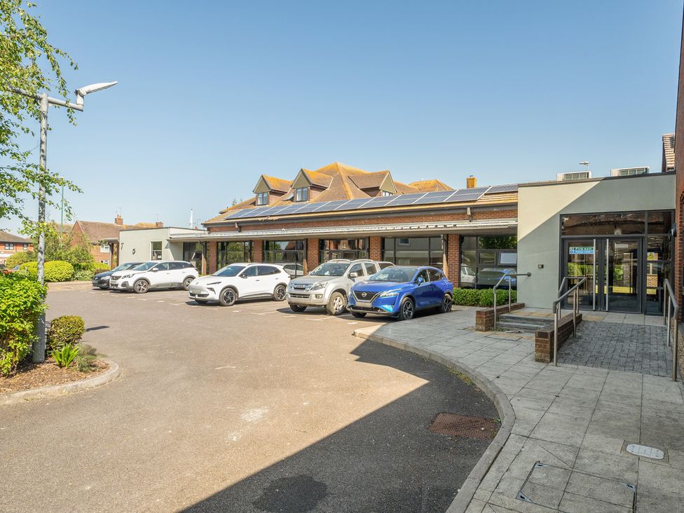 A building with parked cars and entrance at Marine Court Second-floor Double Bedroom with Bathroom Littlehampton