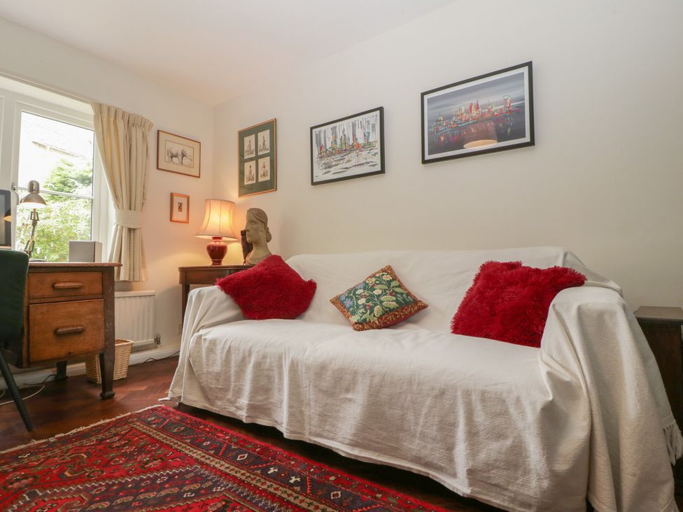 A living room with a couch and desk at St. Marys House, Church Westcote near Bledington