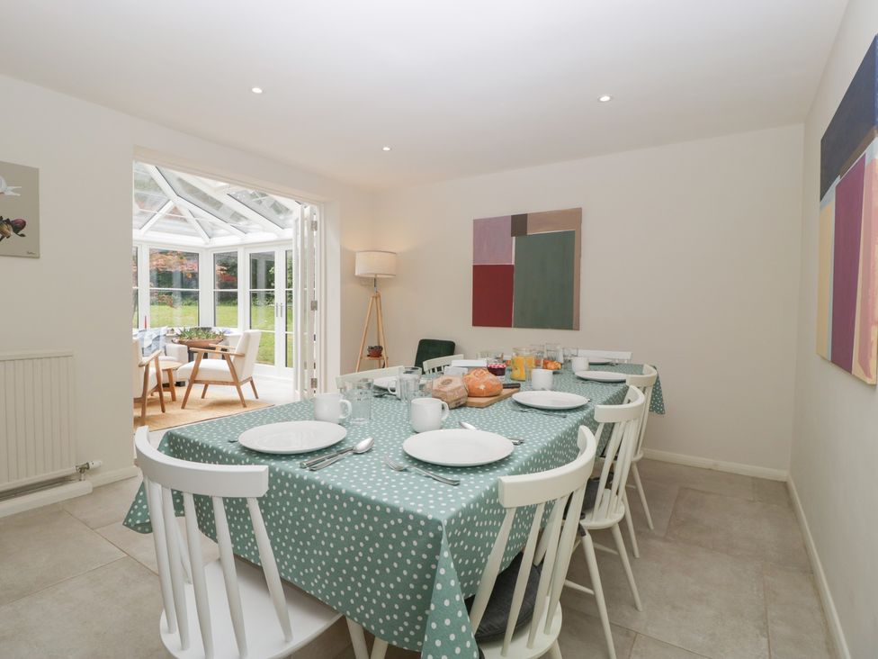 A dining room with a table set for a meal at St. Marys House Church Westcote near Bledington
