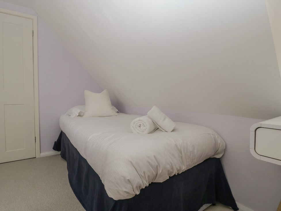 A bedroom with a bed and towels at St. Marys House Church Westcote near Bledington