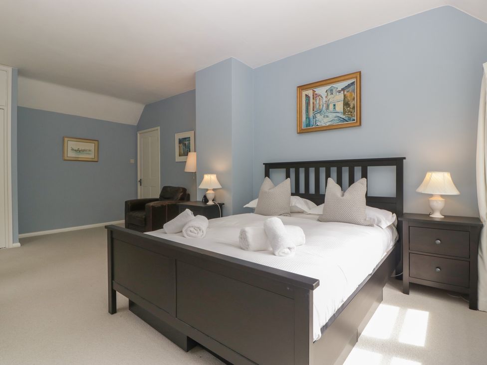 A bedroom with a bed and a chair at St. Marys House in Church Westcote near Bledington