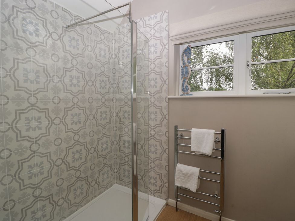 A bathroom with a shower and towel rack at St. Marys House in Church Westcote near Bledington
