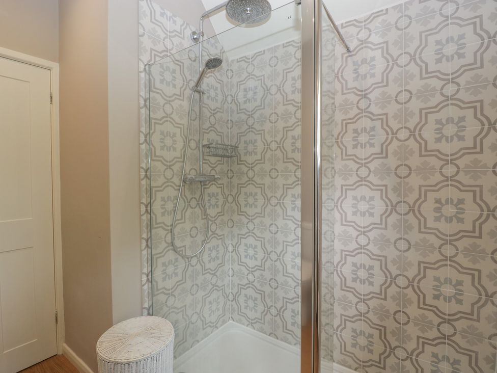 A shower enclosure with patterned tiles at St. Marys House, Church Westcote near Bledington