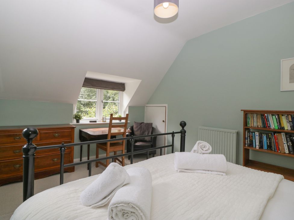 A bedroom with a bed and bookshelf at St. Marys House in Church Westcote near Bledington
