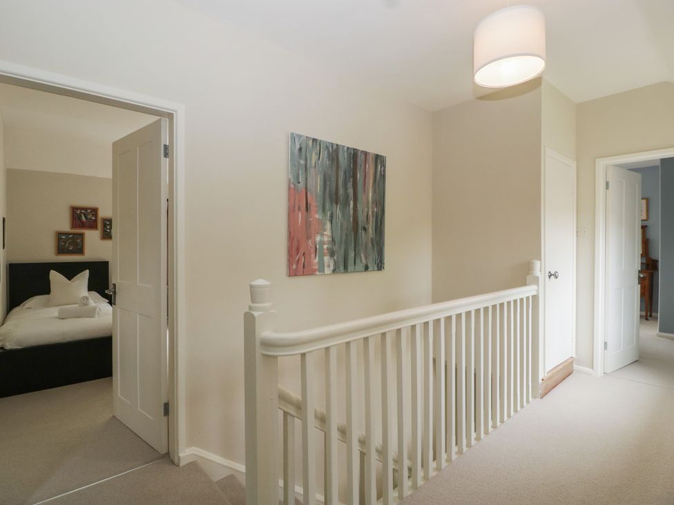 A hallway with a door leading to a bedroom at St. Marys House, Church Westcote near Bledington