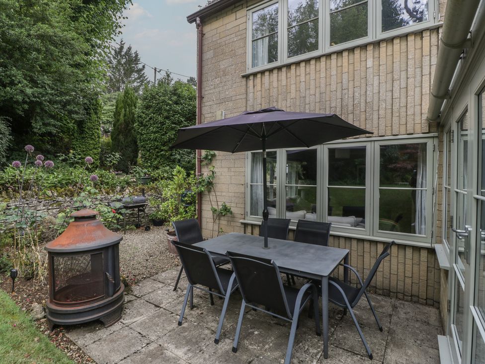 An outdoor patio with a table and chairs at St. Marys House Church Westcote near Bledington