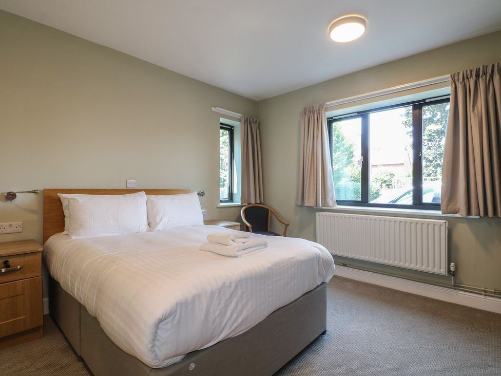 A bedroom with a bed and chair at Bedroom 1 in Littlehampton
