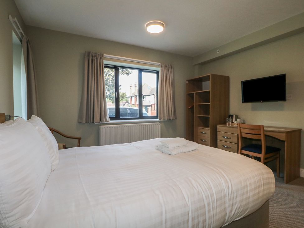 A bedroom with a bed, window, and dresser at Bedroom 1 in Littlehampton