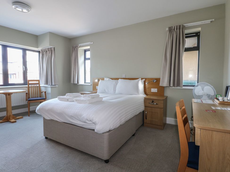 A bedroom with a bed and table at Bedroom 2 in Littlehampton