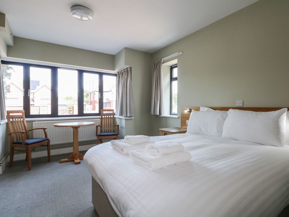 A bedroom with a bed and a table at Bedroom 2 in Littlehampton