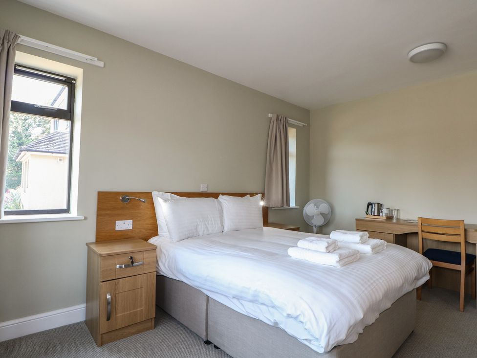 A bedroom with a bed and desk at Bedroom 2 in Littlehampton