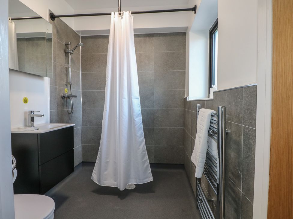 A bathroom with a shower and sink at Bedroom 2 in Littlehampton