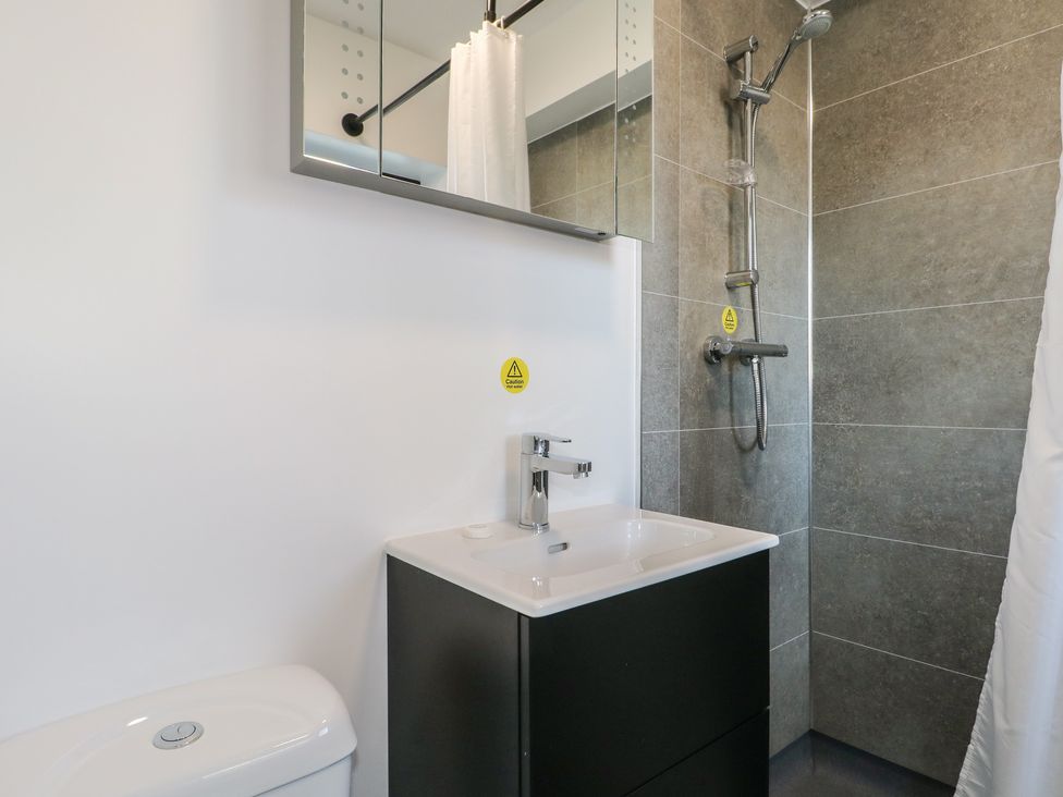 A bathroom with a sink, toilet and shower at Bedroom 2 in Littlehampton
