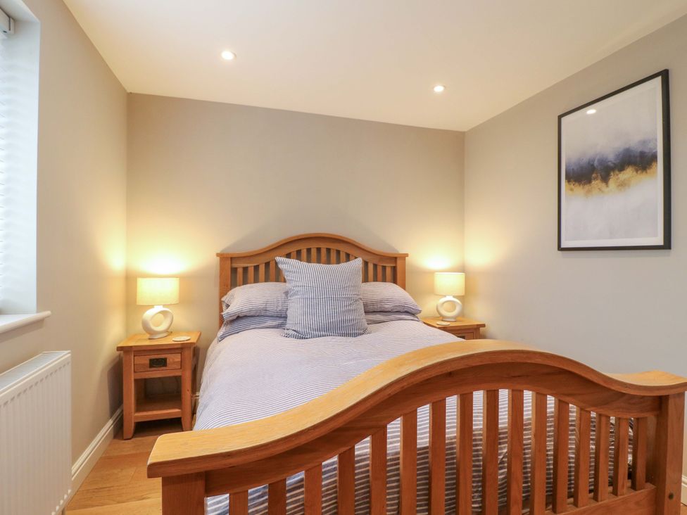 A bedroom with a bed and bedside tables at Farm View House in Somerby