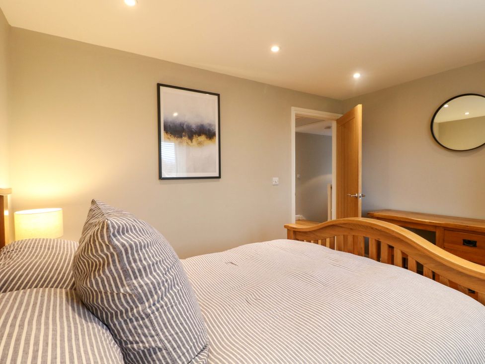 A bedroom with a bed and a lamp at Farm View House in Somerby