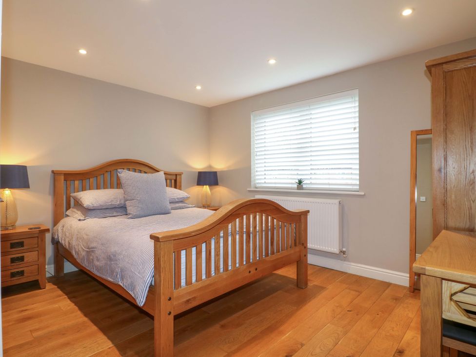 A bedroom with a bed and bedside table at Farm View House Somerby
