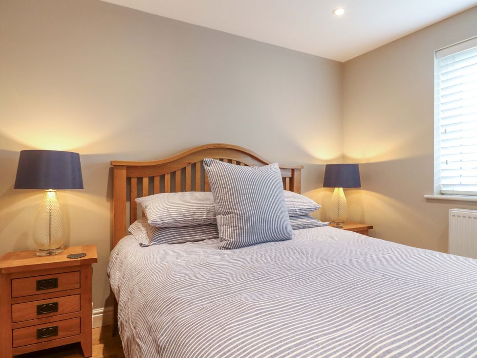 A bedroom with a bed and lamps at Farm View House in Somerby