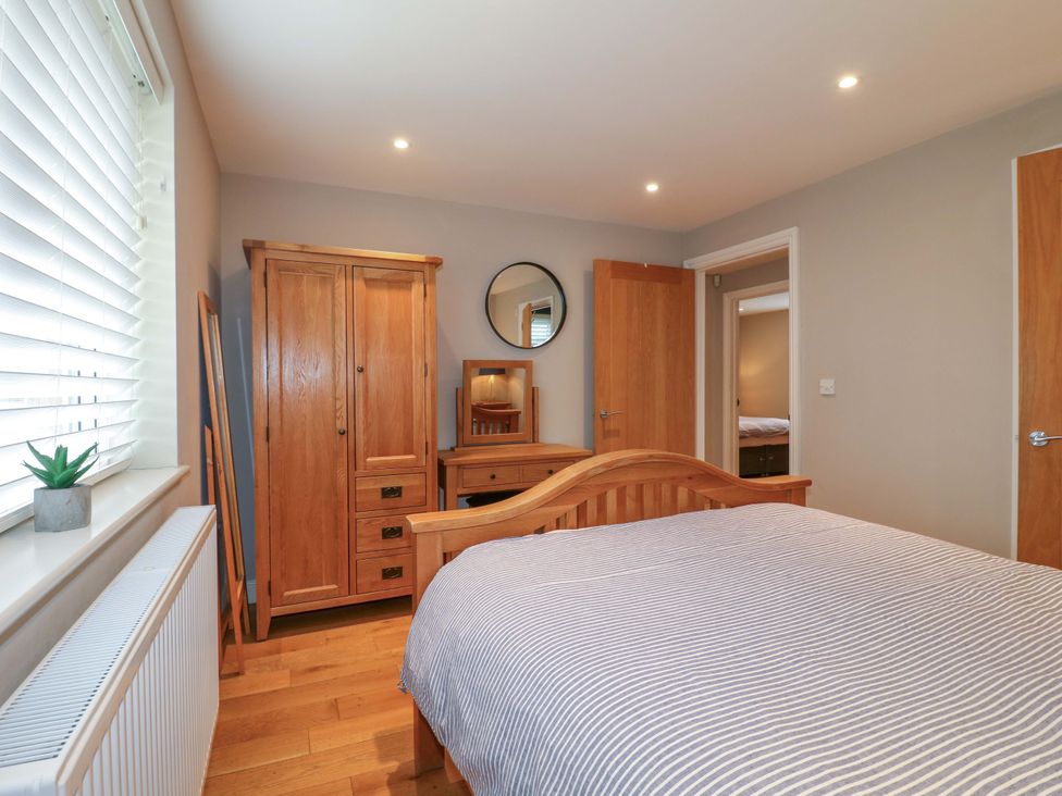 A bedroom with a bed and wardrobe at Farm View House in Somerby