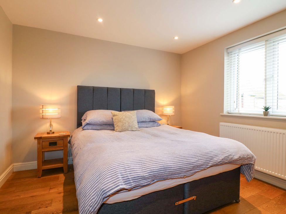 A bedroom with a bed and bedside tables at Farm View House in Somerby