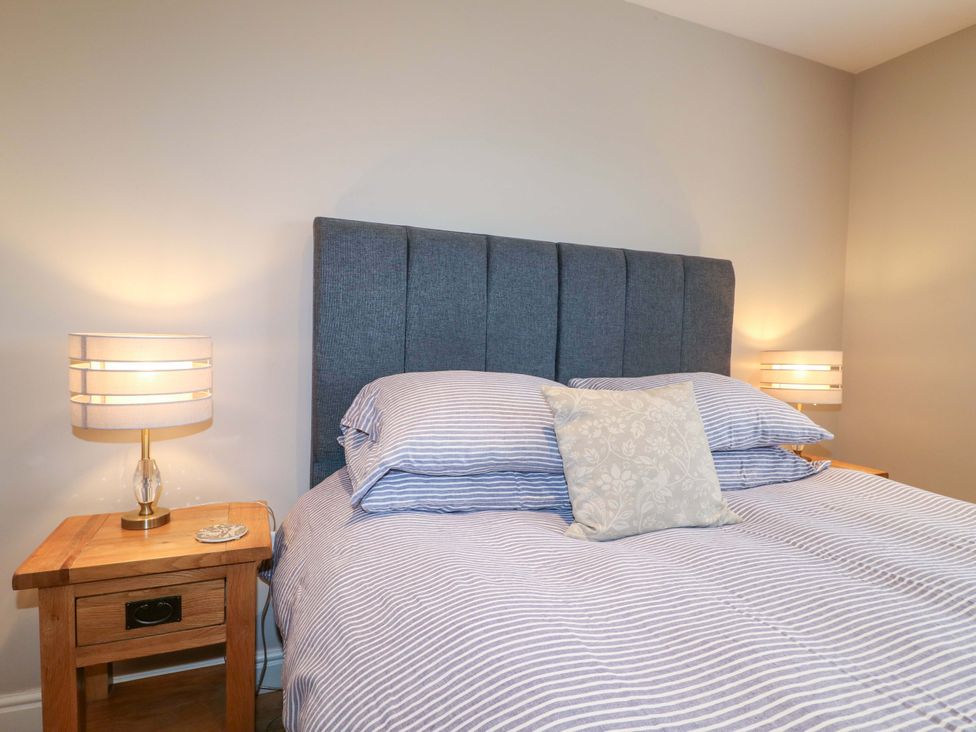 A bedroom with a bed and bedside table at Farm View House in Somerby