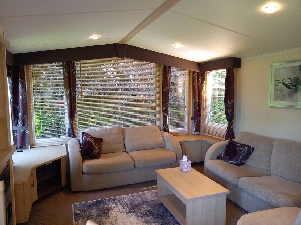 A living room with sofas and a coffee table at Emma No.6 in Llandegfan